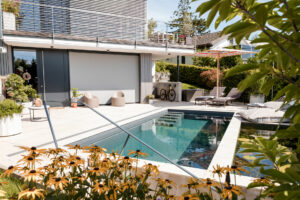 The pool and the house are connected to the house.